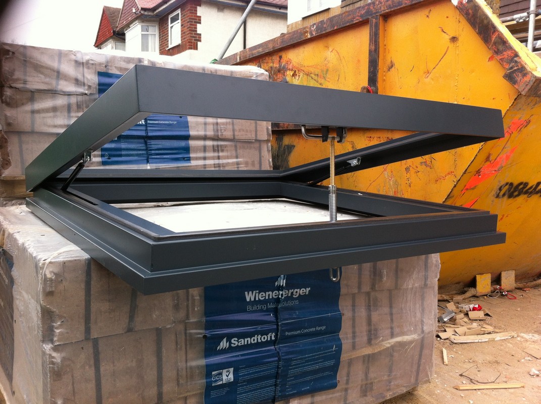 Opening flat roof skylight in anthracite grey installed in West Kensington