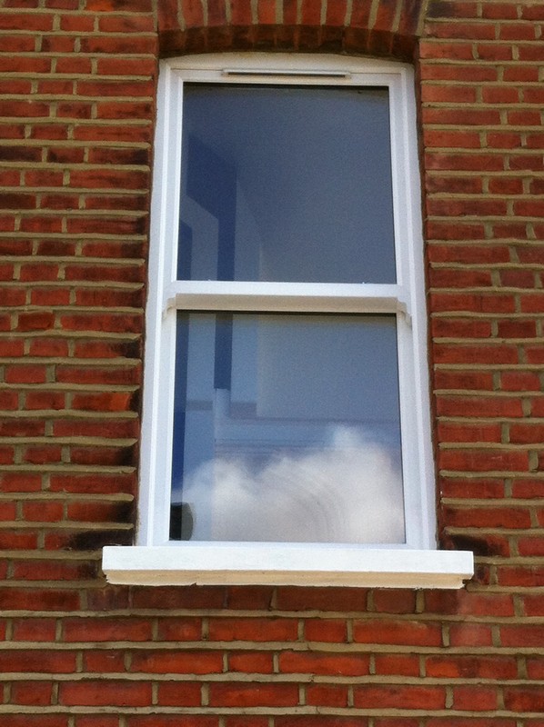 uPVC sash window on Victorian red brick house in West Kensington